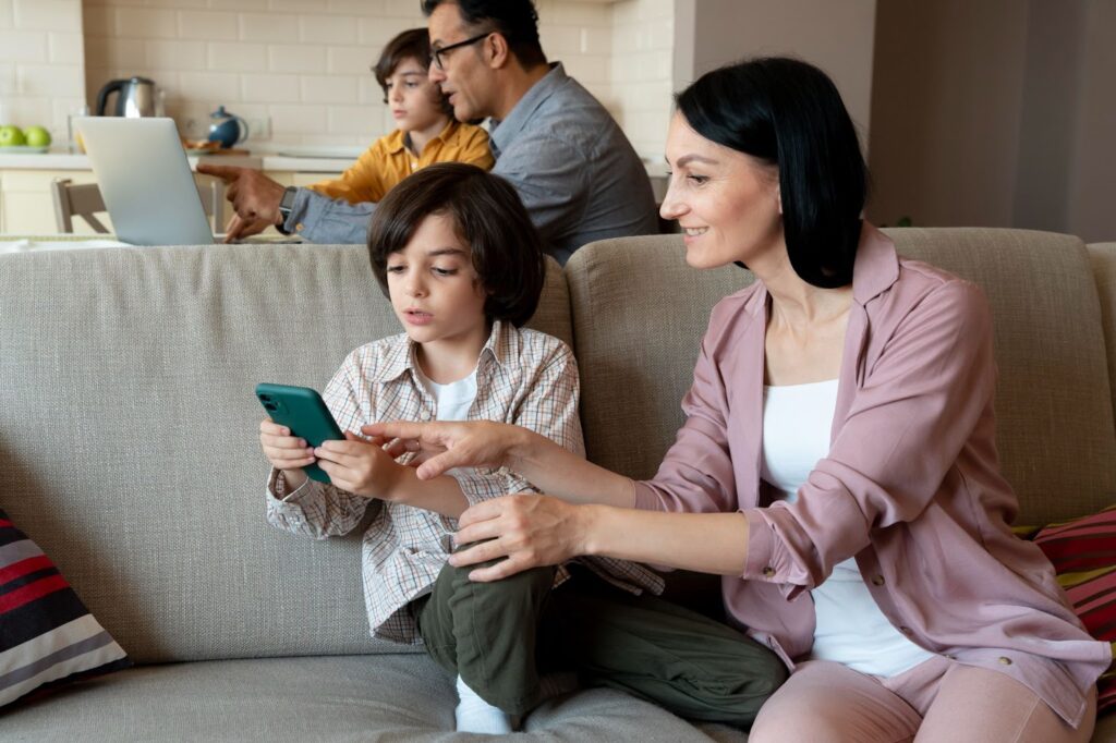Parents watching what their kids are doing on their phone and laptop.